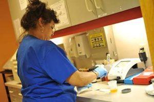 Tri-City staff member works with medical samples
